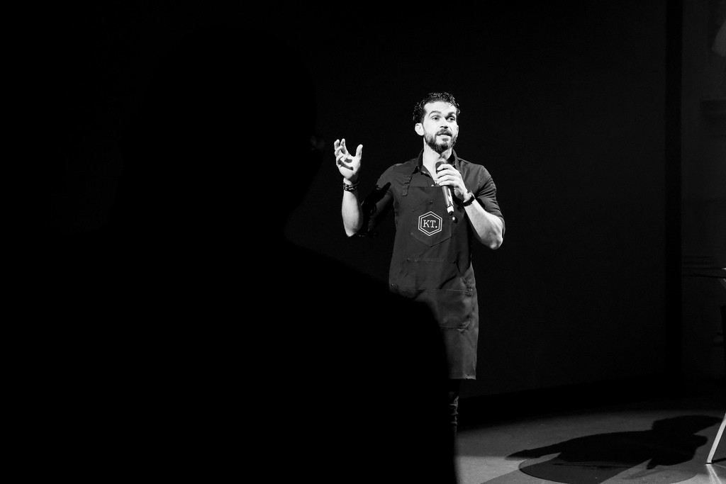 Speaker-led alternative: Monochrome stage image with generous dark space.